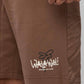 Stylera logo brown shorts on model showing hem and pocket detail trendy brown shorts for everyday wear
