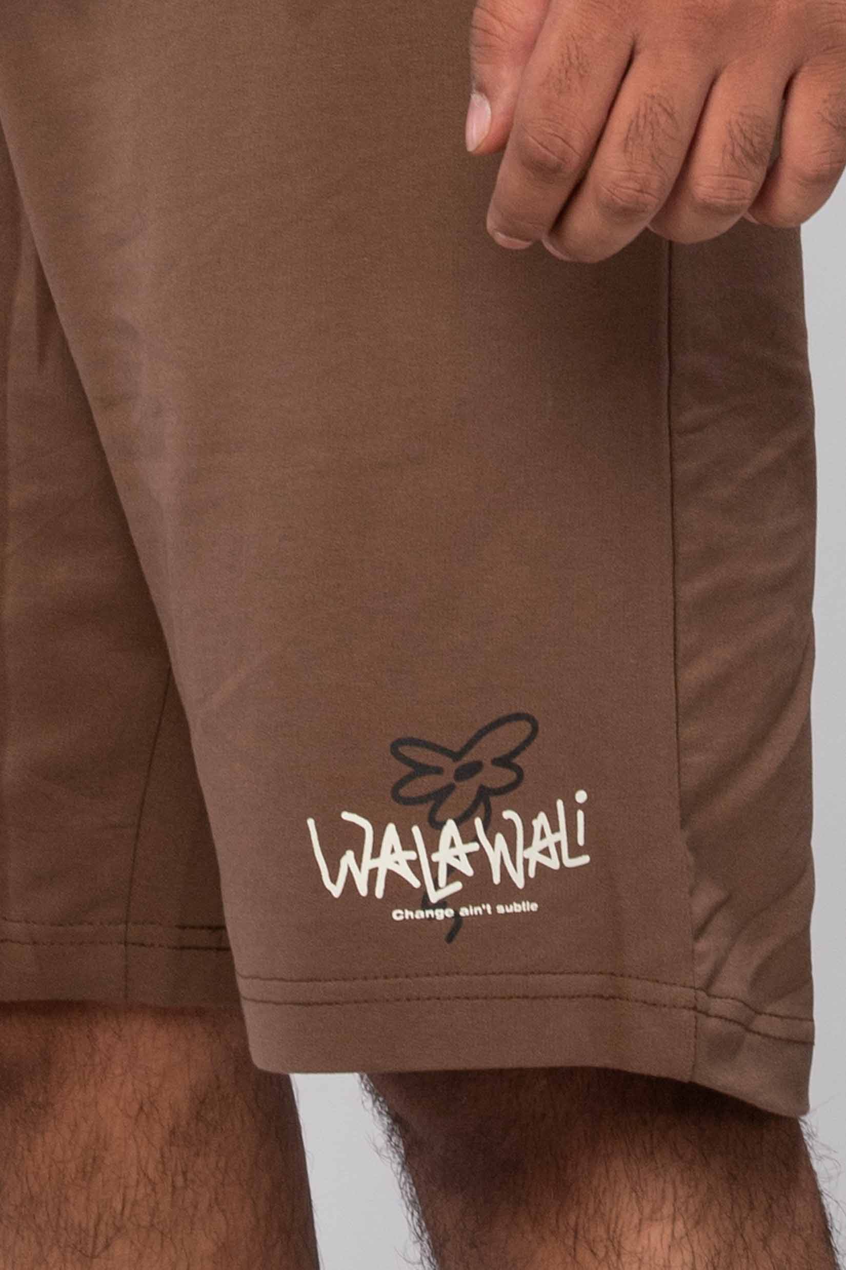 Stylera logo brown shorts on model showing hem and pocket detail trendy brown shorts for everyday wear