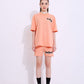 Stylera peach oversized tee set on model featuring trendy oversized casual t-shirt with matching shorts and sneakers