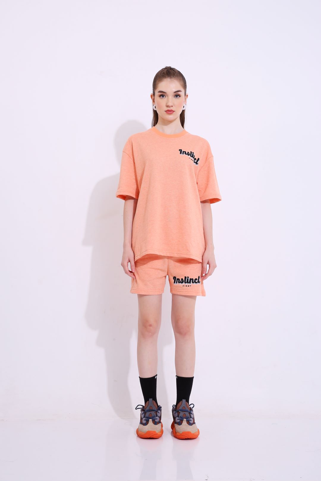 Stylera peach oversized tee set on model featuring trendy oversized casual t-shirt with matching shorts and sneakers