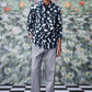 Man wearing trendy printed shirts for men by Stylera paired with gray pants and black shoes
