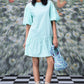 Stylera mint dress with lace puff sleeves and ruffled hem holding sequin bag trendy sequin dresses for women