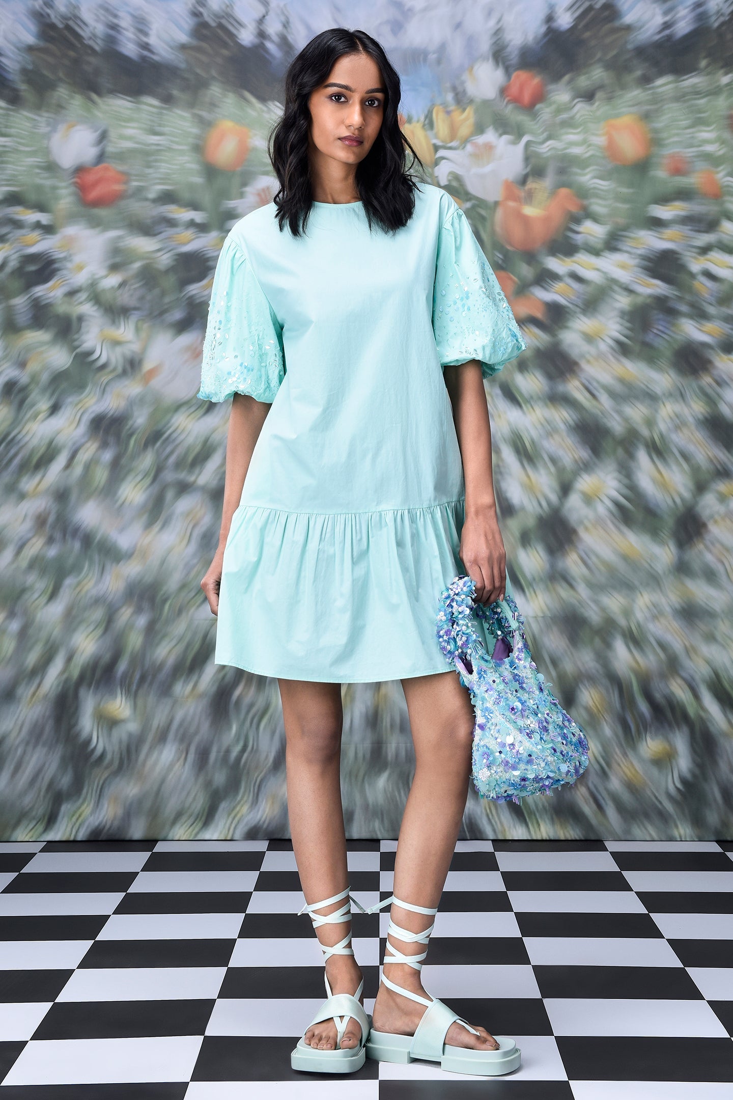 Stylera mint dress with lace puff sleeves and ruffled hem holding sequin bag trendy sequin dresses for women