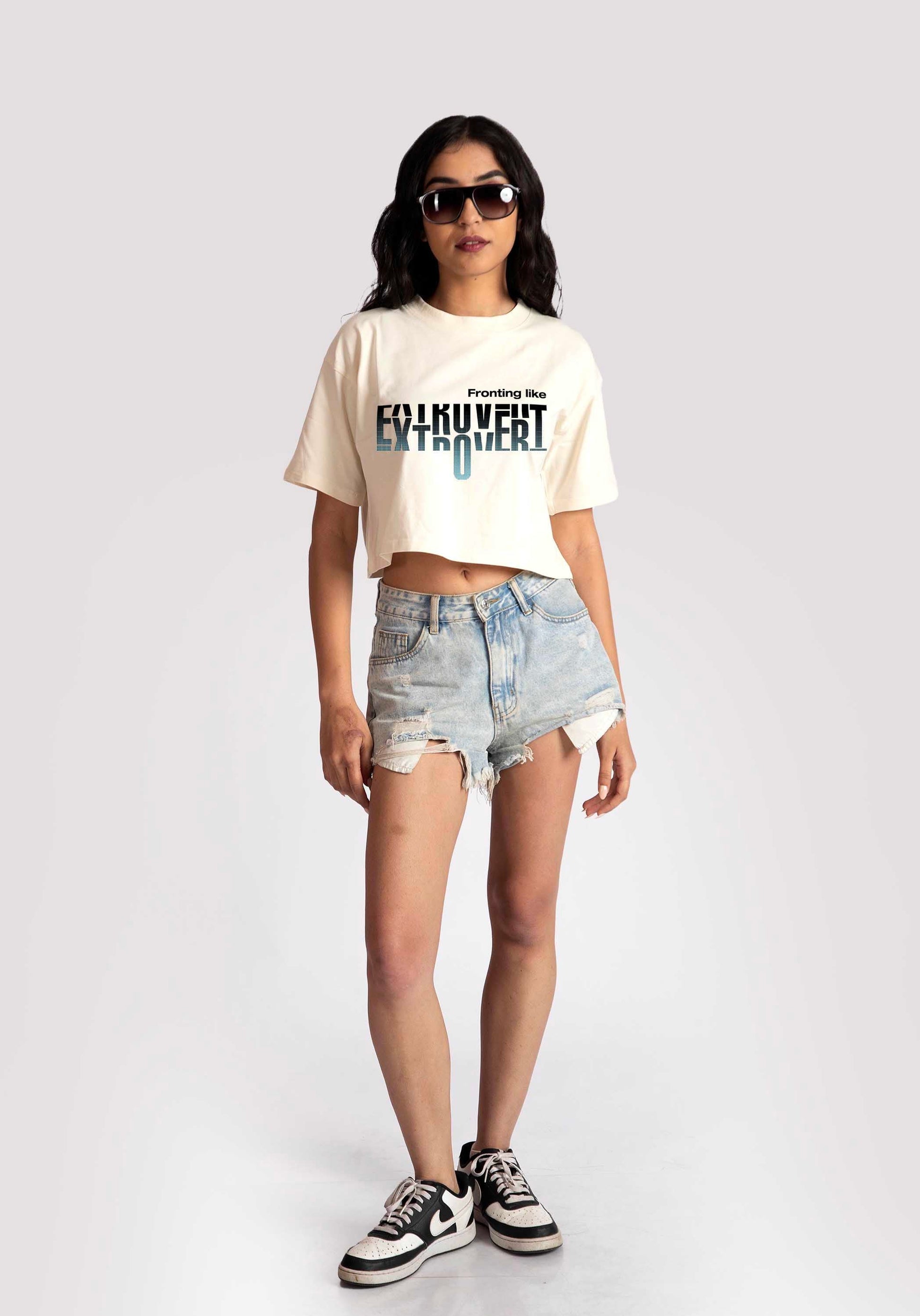 Stylera white oversized crop fit tee with graphic print worn with denim shorts and sneakers