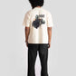 Back view of man wearing white oversized printed t-shirt with graphic design and black pants