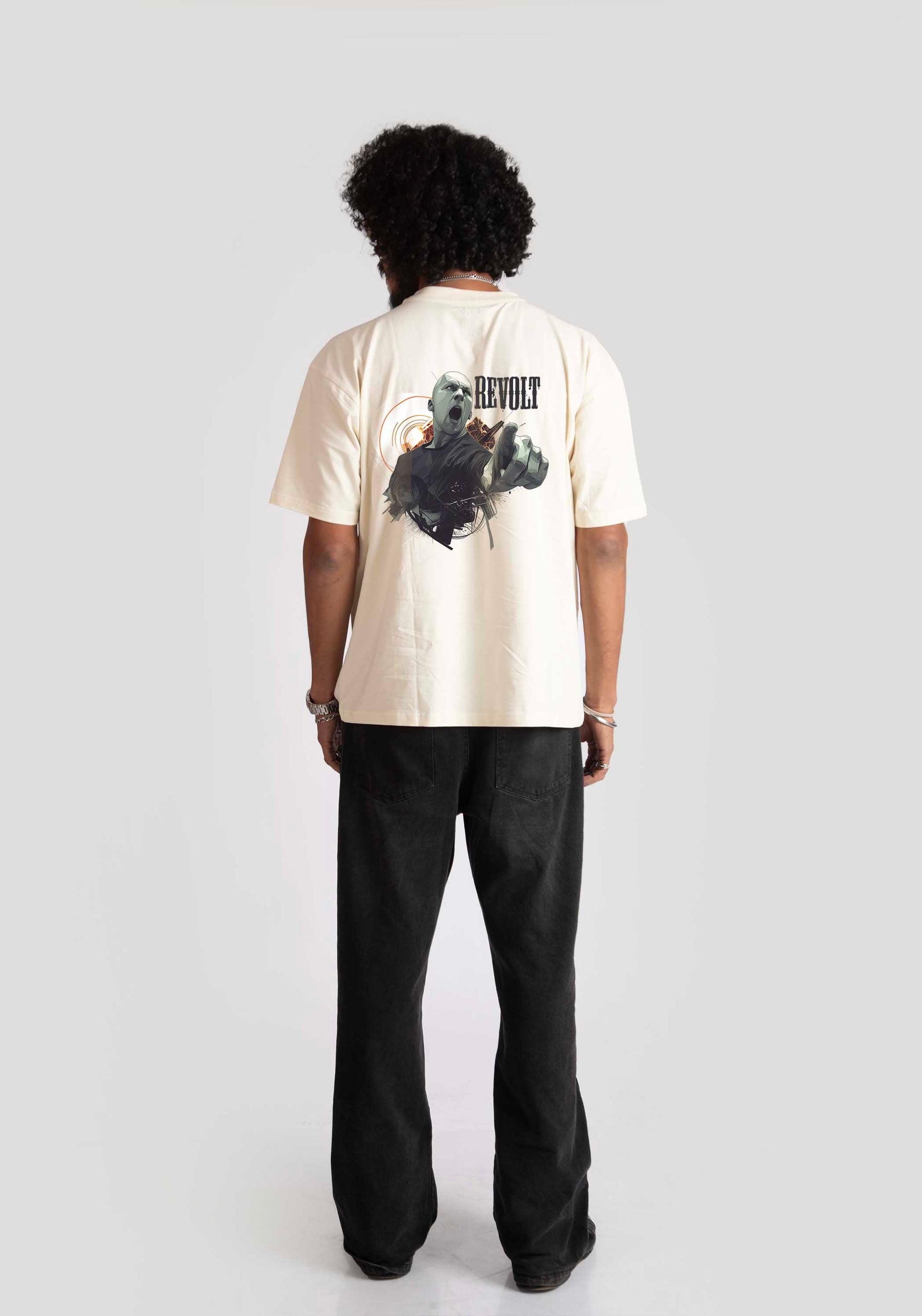 Back view of man wearing white oversized printed t-shirt with graphic design and black pants