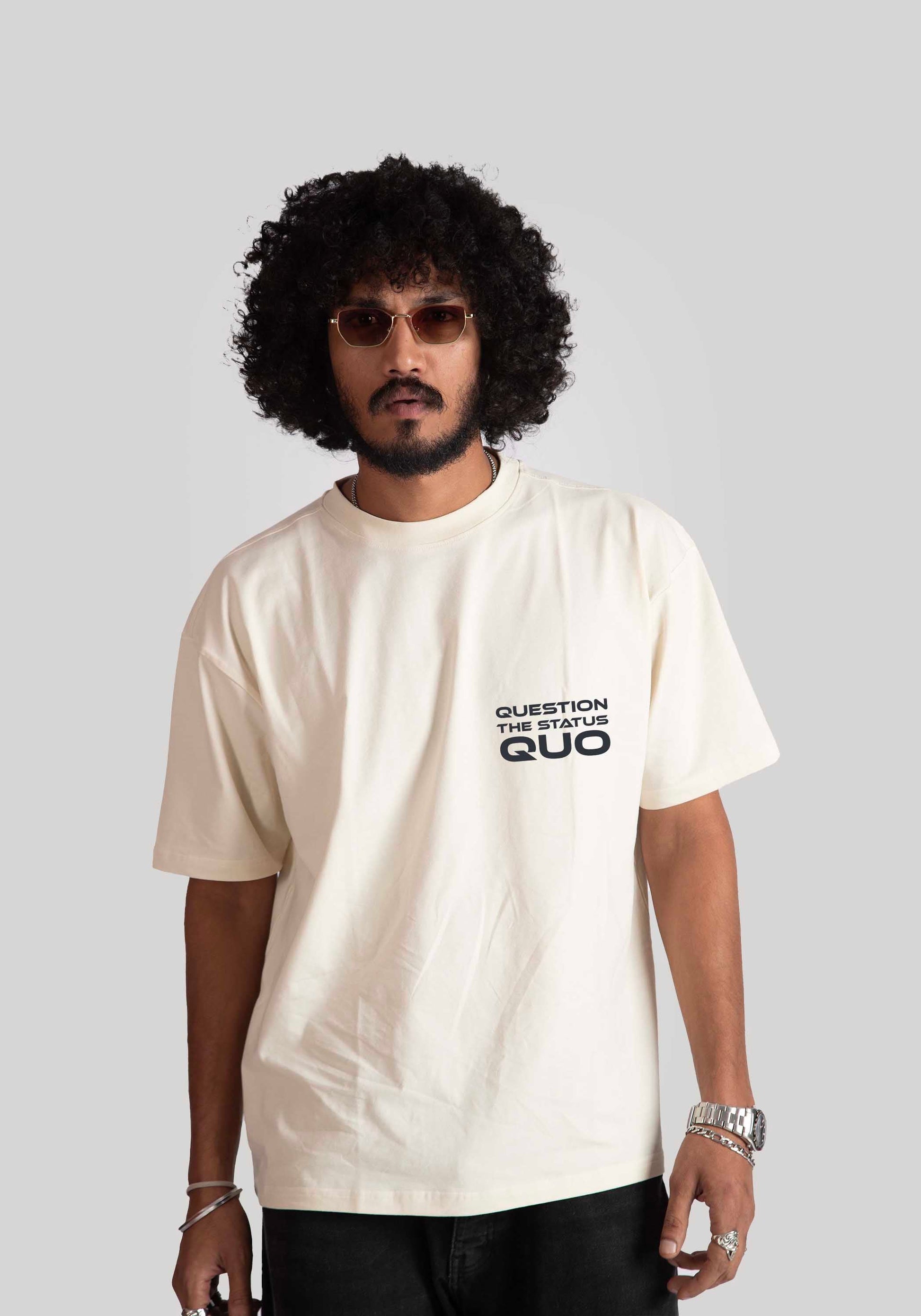 Stylera white oversized printed t-shirt with question the status quo text worn by male model