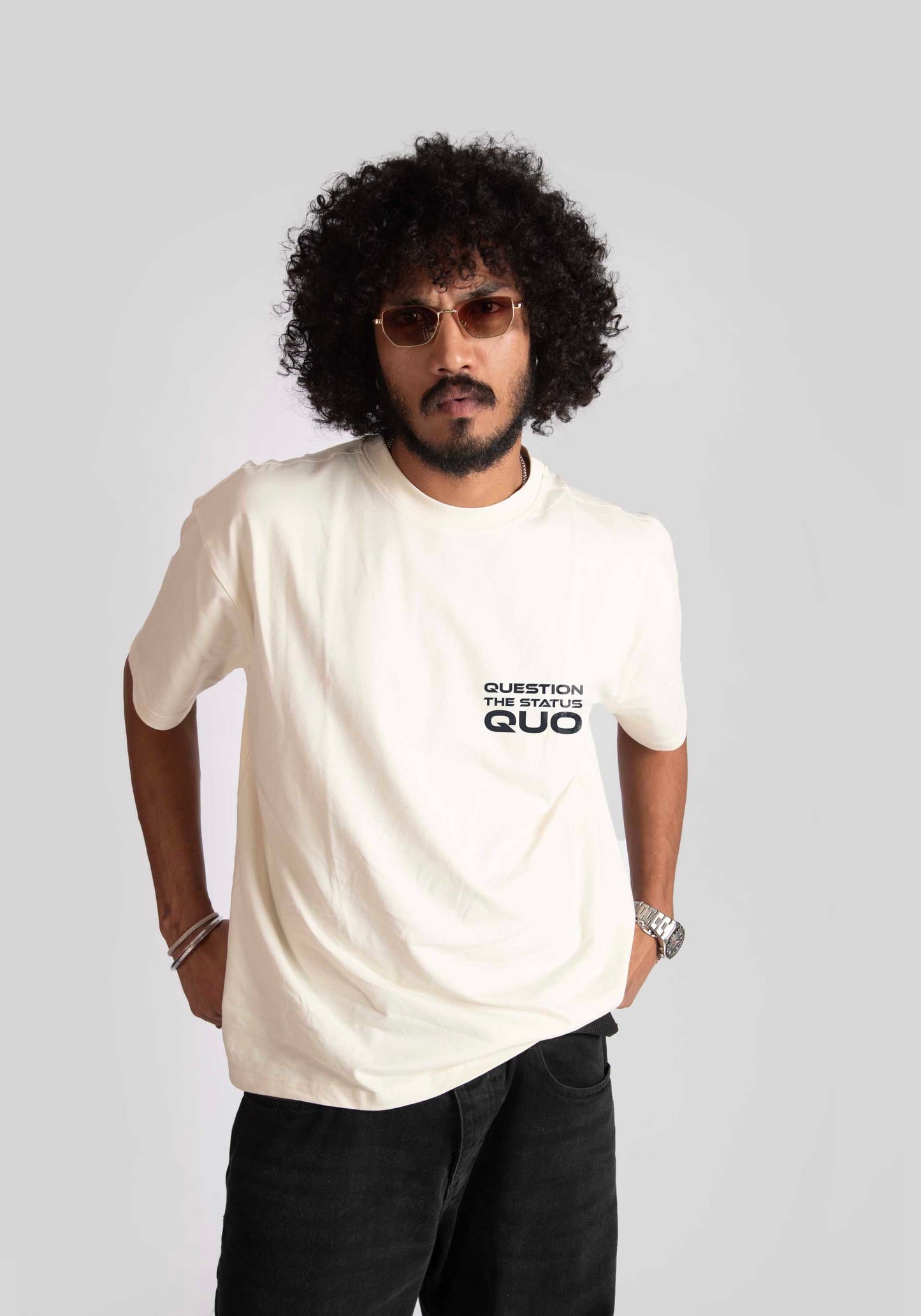 Man wearing a white oversized printed t-shirt with black text on the front by Stylera