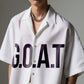 Stylera  model wearing white trendy summer shirt short sleeve with bold GOAT print open collar and chain