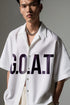 Stylera  model wearing white trendy summer shirt short sleeve with bold GOAT print open collar and chain