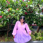 Young woman wearing Stylera women's purple gradient dress with puff sleeves and white ankle boots outdoors