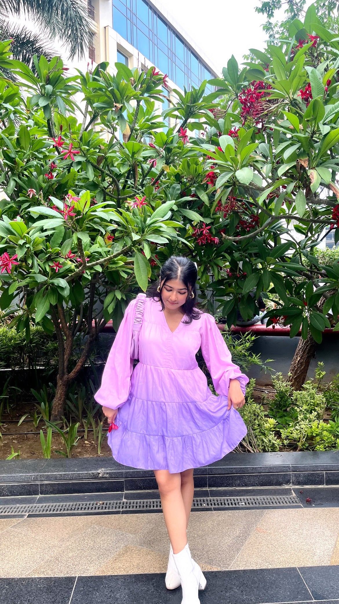 Young woman wearing Stylera women's purple gradient dress with puff sleeves and white ankle boots outdoors