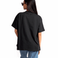 Stylera women's relaxed fit black tee shown from the back worn with blue jeans and sunglasses