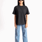 Stylera women's relaxed fit black tee worn with blue jeans and sunglasses