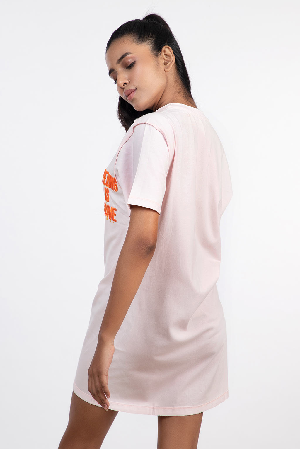 Stylera light pink short sleeve tee seen from back with orange front print women's skinny fit top