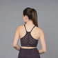 A woman with a ponytail is shown from the back against a gray background, wearing the Wine Sports Bra—a moisture-wicking fitness garment in dark wine.