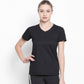 A woman wears the Tuna London Sara Basic Sports Tee With Net Detailing for Women and black pants with white stripes, standing against a plain white background.