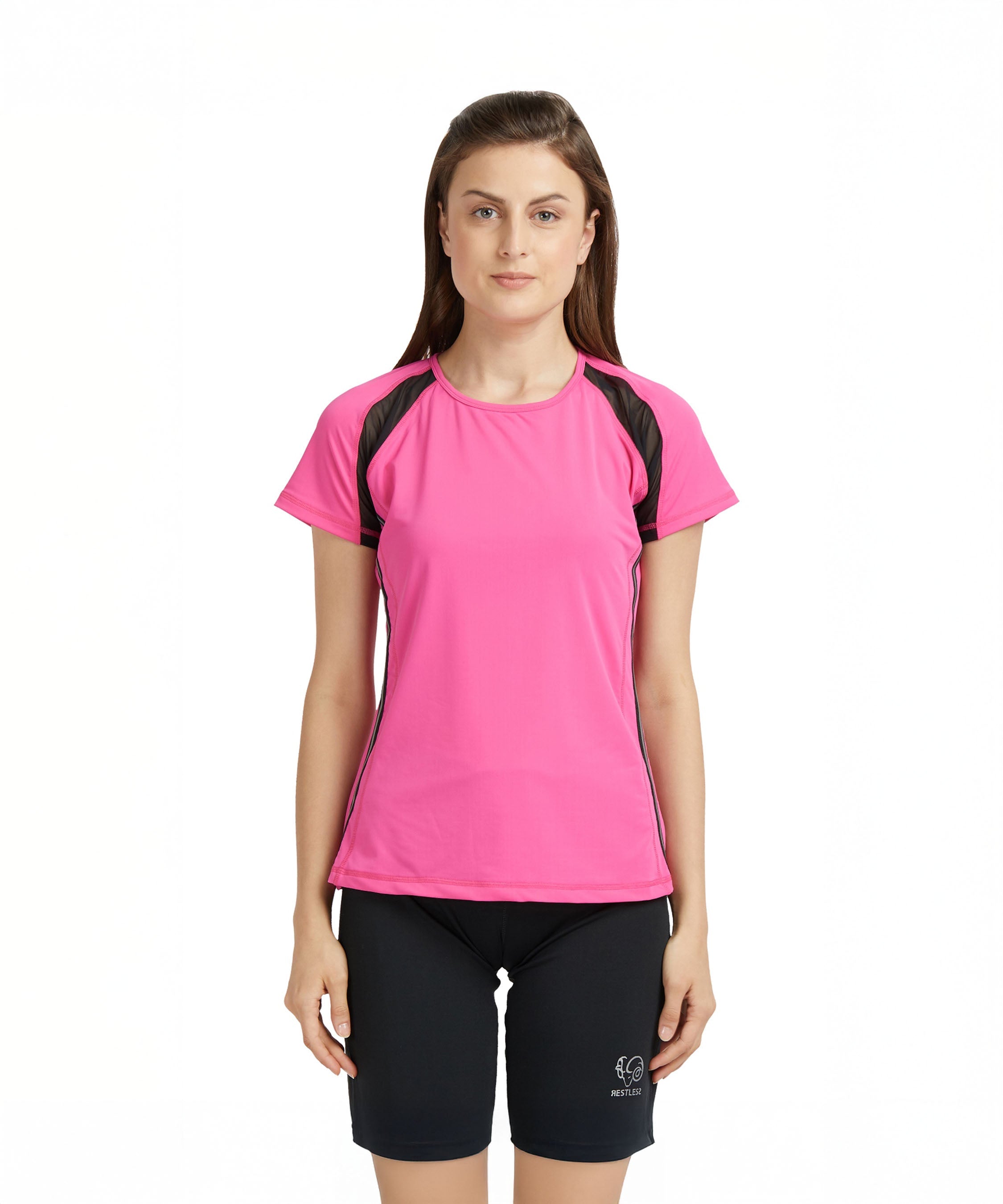 Woman wearing a Tuna London Pink Poly Blend Round Neck Women’s T-Shirt and black shorts stands against a plain white background.