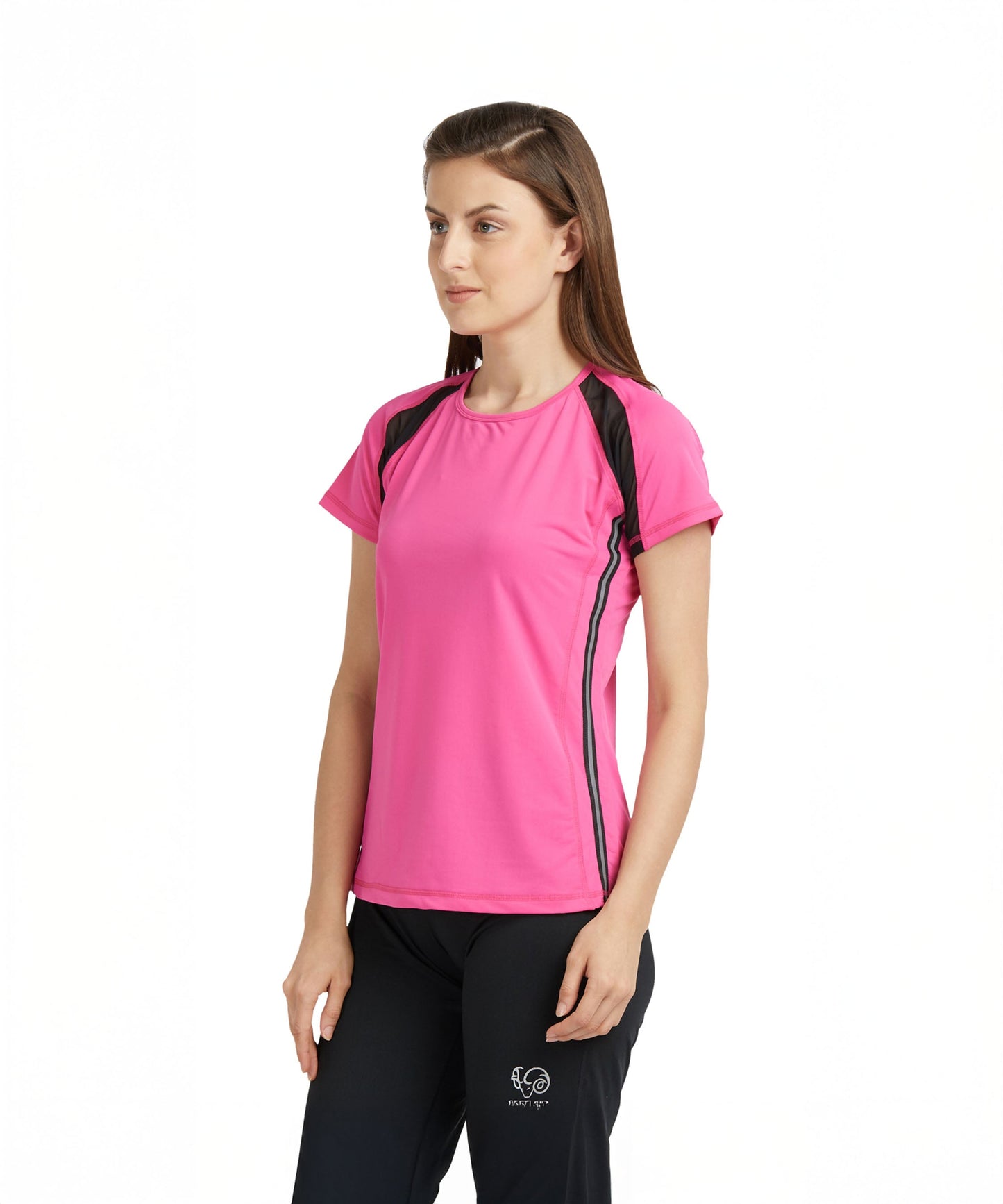 A woman wears a Tuna London Pink Poly Blend Round Neck Women’s T-Shirt with black pants, standing against a white background.