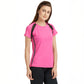 Woman wearing a Tuna London Pink Poly Blend Round Neck Women’s T-Shirt and black pants, standing against a plain white background.