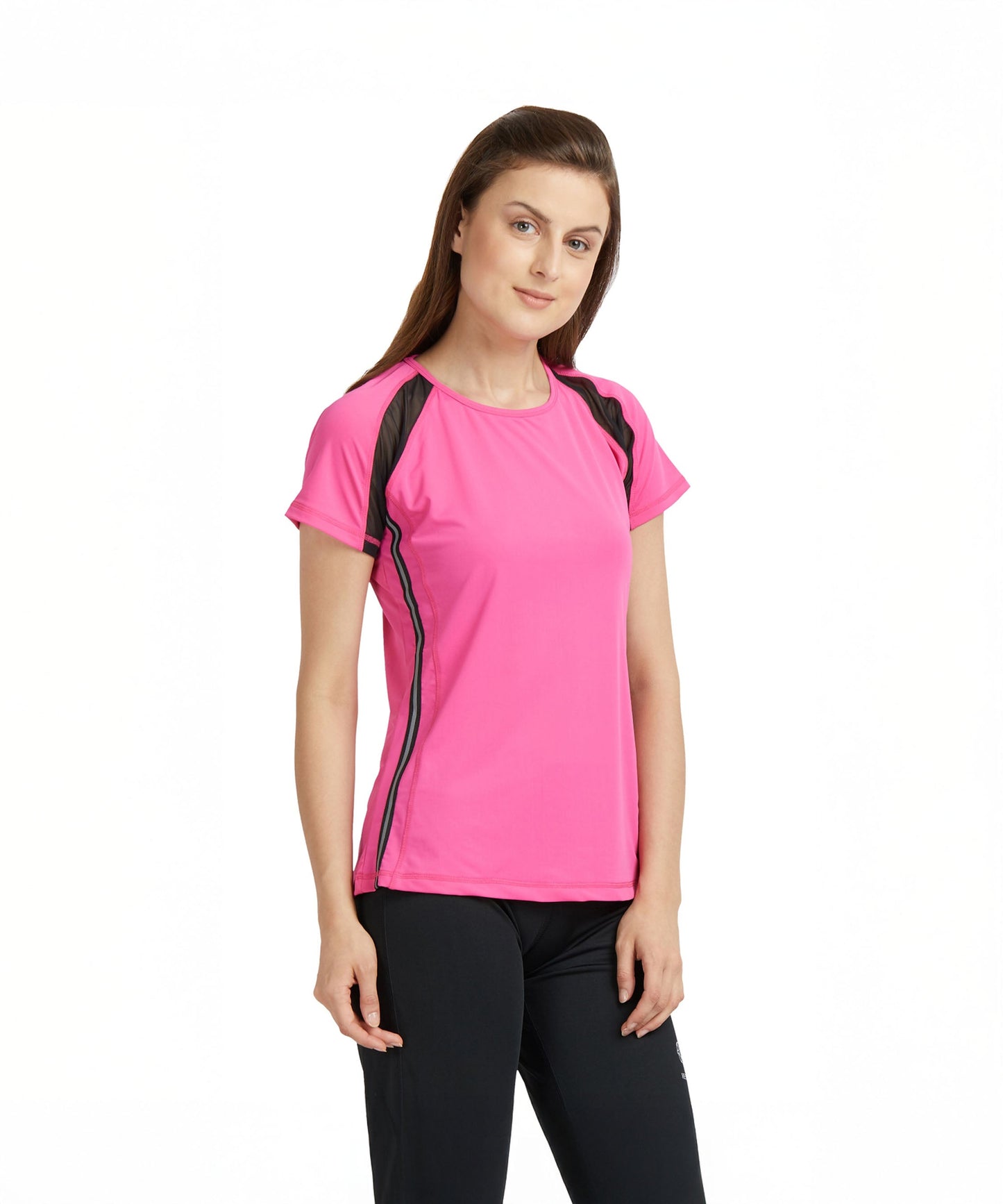 Woman wearing a Tuna London Pink Poly Blend Round Neck Women’s T-Shirt and black pants, standing against a plain white background.