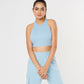 Woman wearing the Blossom Blue Set with a sleeveless crop top and cargo track pants, posing against a plain white background.