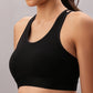 A woman models the Black Sports Bra, featuring adjustable straps, shown from shoulders to midriff against a plain background.