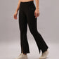 Model wears Black Slit Leggings featuring front slits, paired with white sneakers, standing against a plain background.