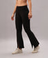 Model wears Black Slit Leggings featuring front slits, paired with white sneakers, standing against a plain background.