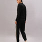 Woman stands against a plain background, looking back and wearing the Black Co-Ord Set made from soft cotton lycra, featuring white side stripes.