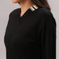 A woman wearing the Black Co-Ord Set featuring a black cotton lycra zip-up jacket with cream striped collar and pocket details, facing left—a chic option for coordinated style.