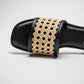 Close-up of black and beige woven sandals for women with open toe design by Stylera