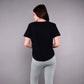 Model wearing a black Adore Your Core printed tee from Stylera with gray leggings