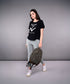 Woman wearing Adore Your Core printed tee with gray leggings and a backpack, showcasing activewear style