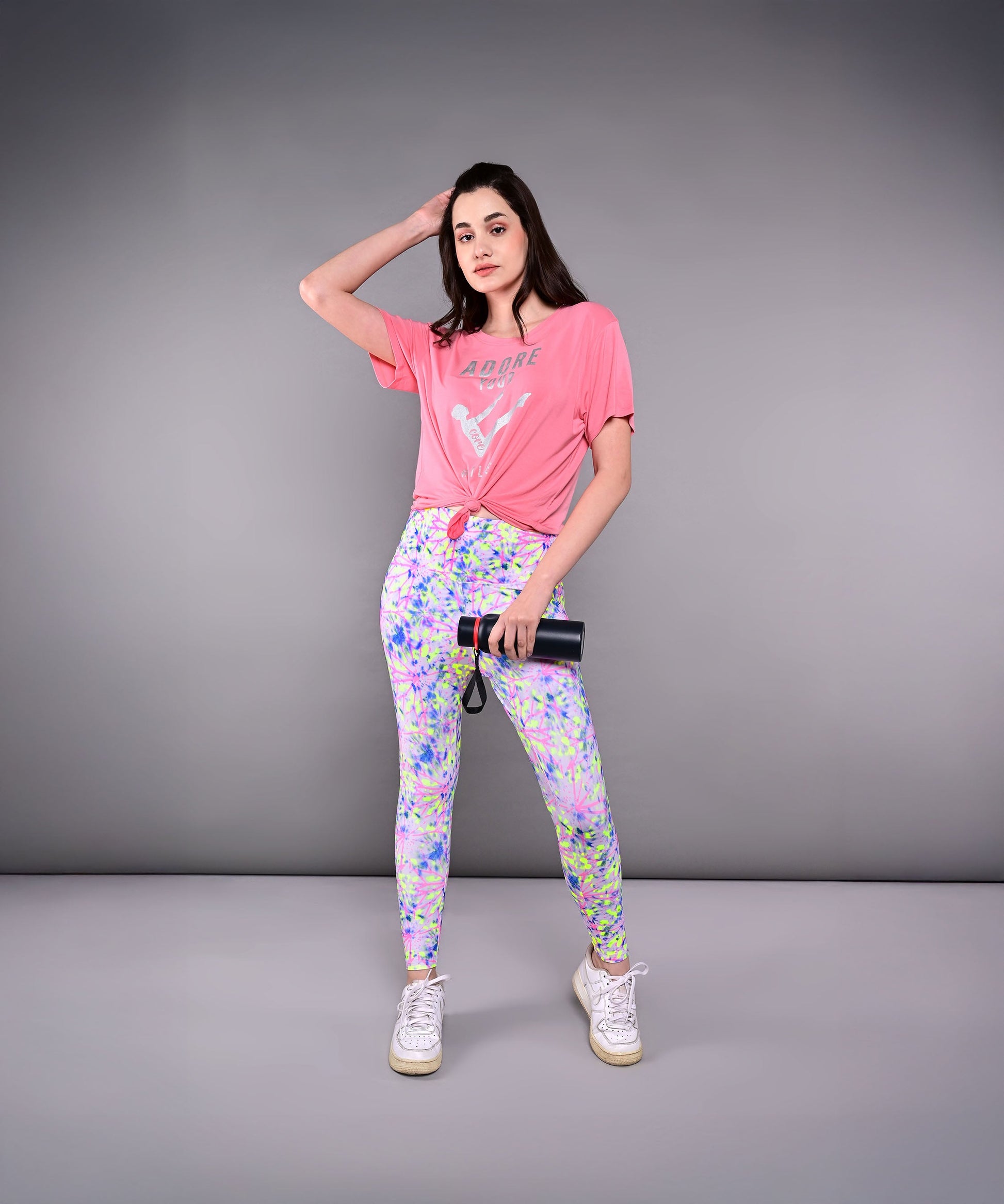 Model wearing Adore Your Core printed tee with colorful leggings for a stylish workout look