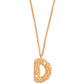 Stylera gold letter D necklace with textured beaded pendant and small clear accent stone on chain