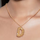 Stylera gold letter D necklace with textured floral pendant and chain worn on model neckline