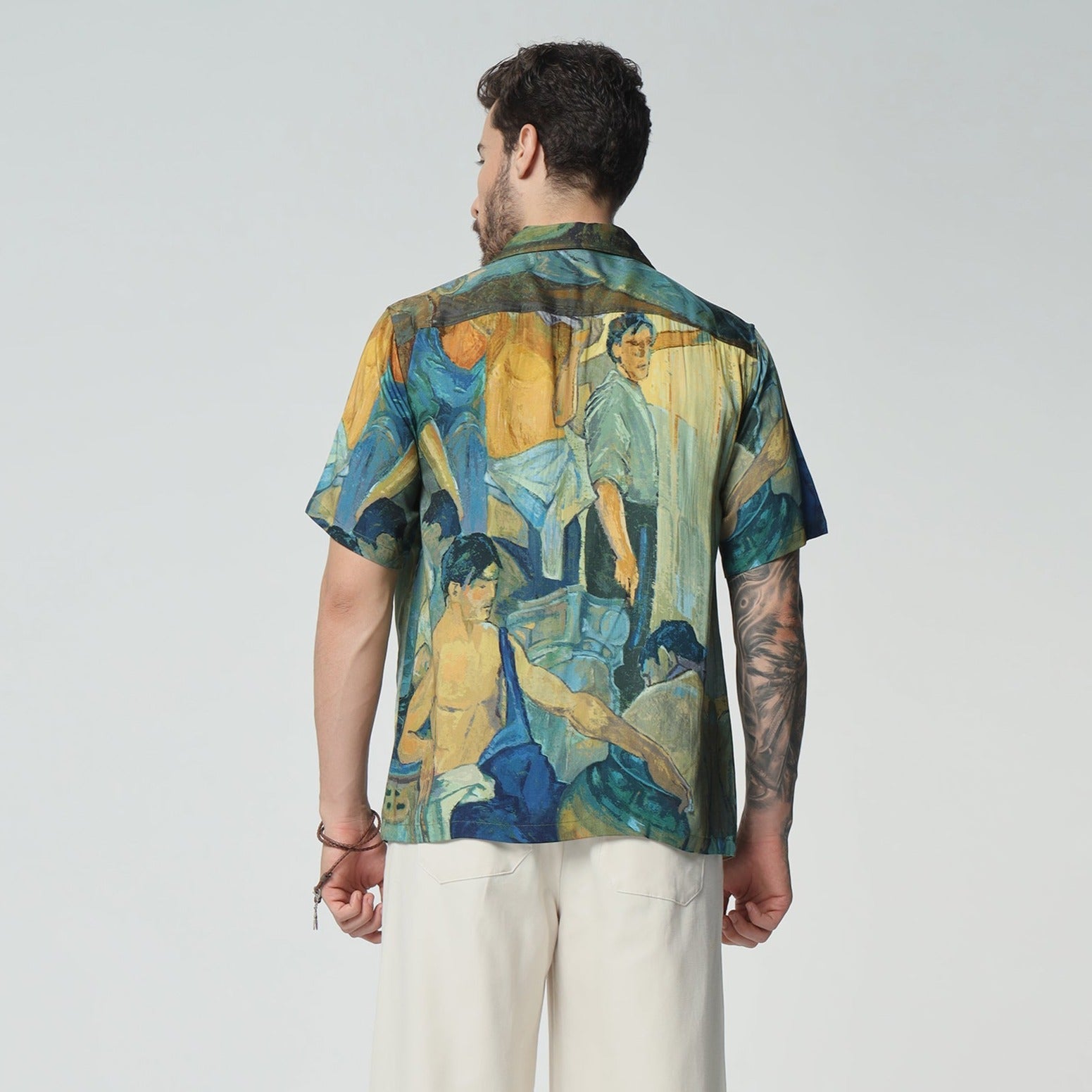Back view of an Artisan print short sleeve shirt featuring vibrant artwork and a relaxed fit