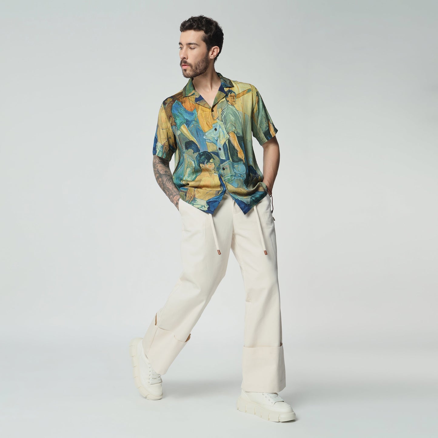 Stylera artisan print short sleeve shirt in vibrant colors, paired with casual trousers for a stylish look