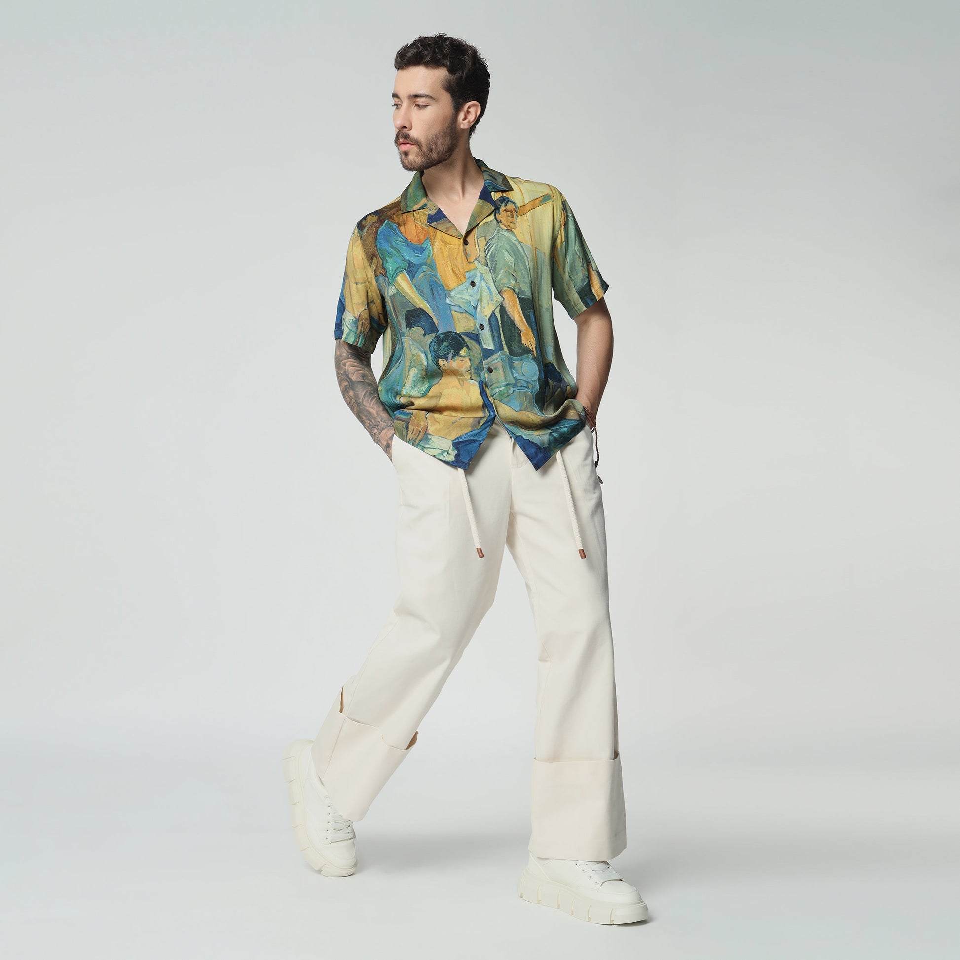 Stylera artisan print short sleeve shirt in vibrant colors, paired with casual trousers for a stylish look