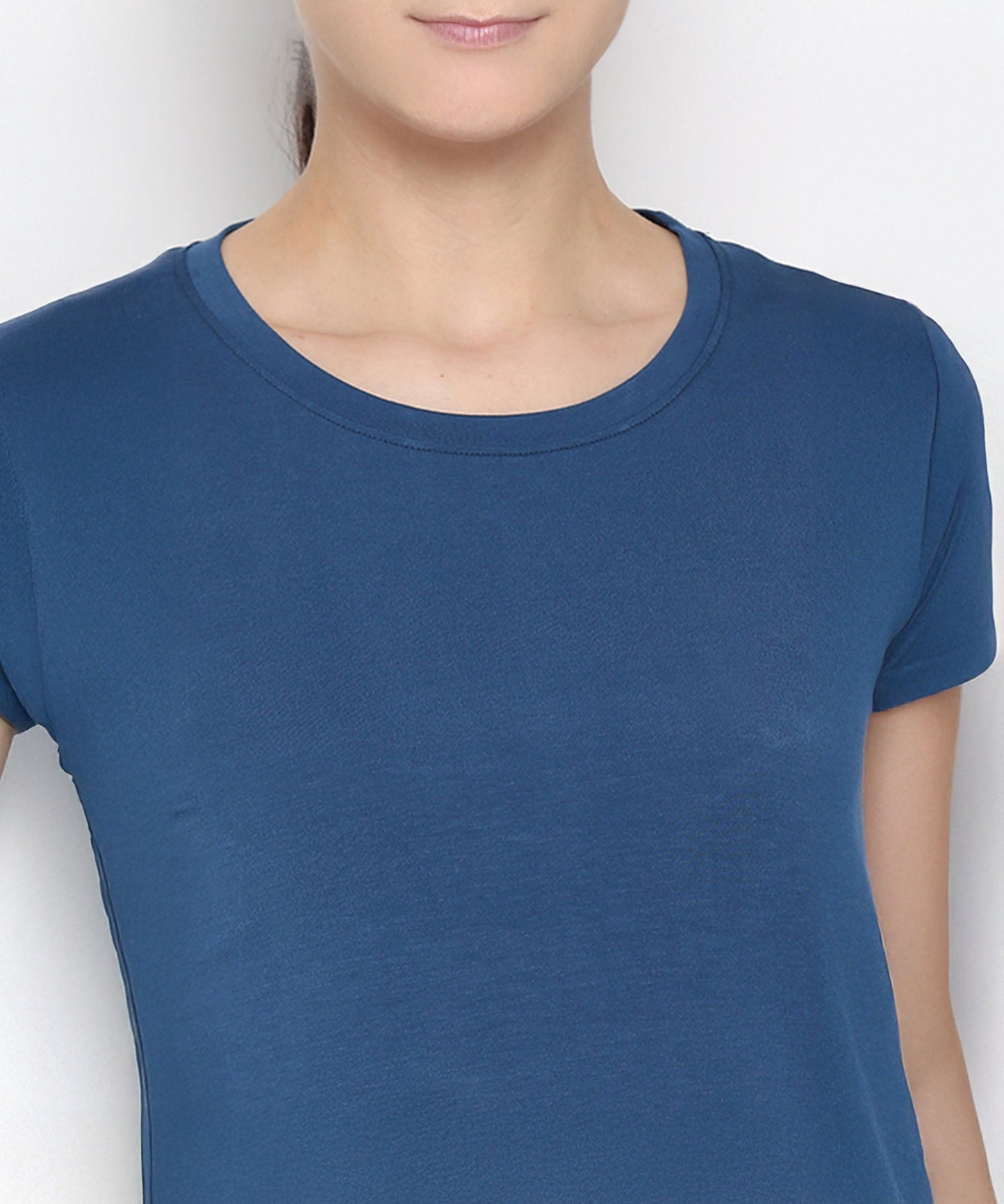 Close-up of a woman's top in Atlantic Blue activewear set, featuring a soft fabric and classic crew neckline