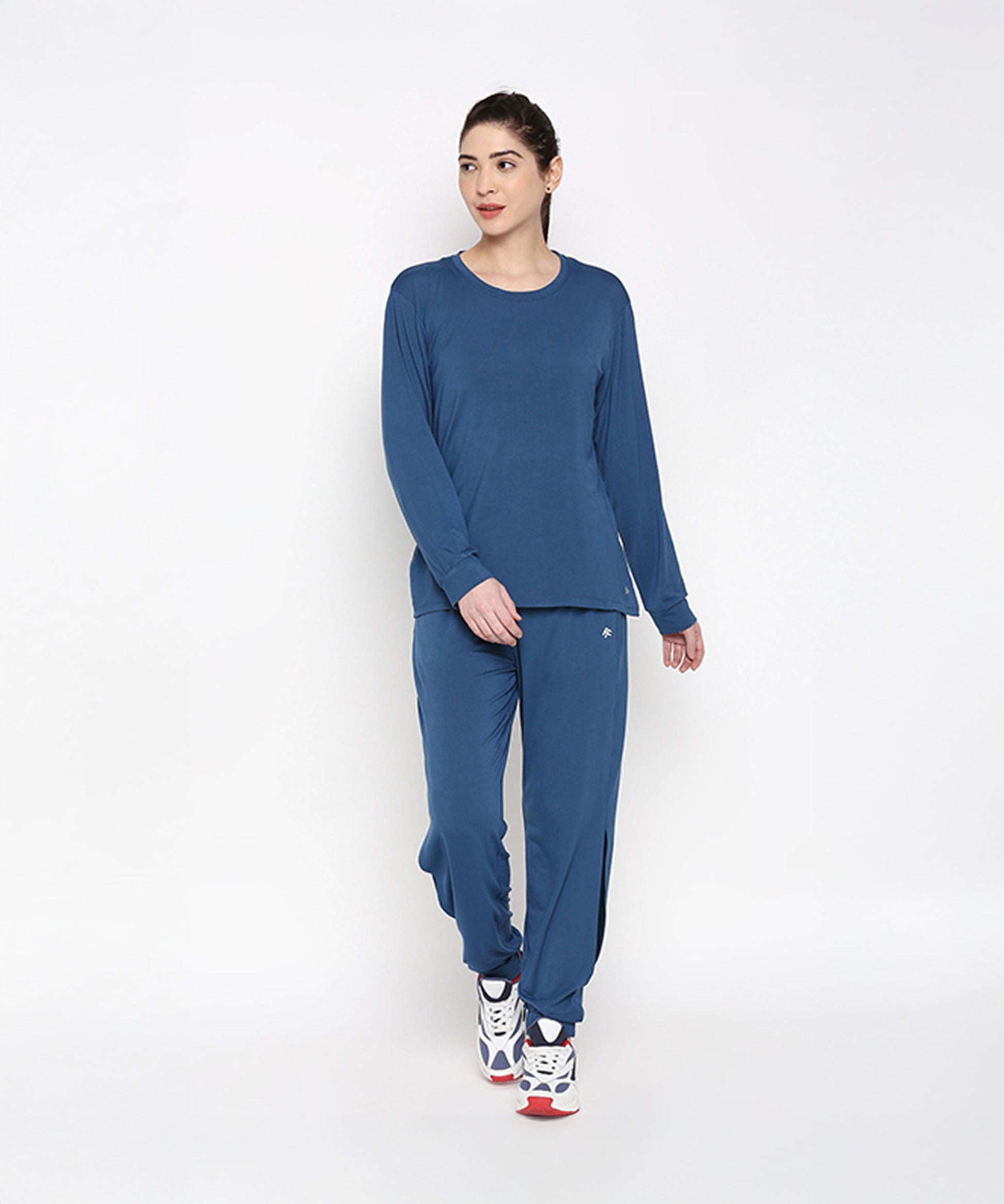 Woman modeling Atlantic Blue Activewear Set, featuring long sleeves and comfortable pants for workouts