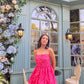 Model wearing a hot pink Barbie balloon dress with thin straps posed by pastel cafe window