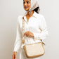 Beige crossbody purse from Stylera, stylishly worn with a white outfit and scarf