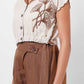 Stylera beige embroidered linen top with brown floral embroidery and button closure