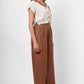 Side view of a woman wearing Western Era beige embroidered linen top with brown wide-leg pants