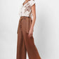 Stylera beige embroidered linen top with button front and floral design worn with brown wide-leg pants