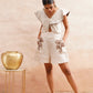 Stylera beige embroidered playsuit with floral designs and flutter sleeves styled with sandals