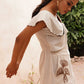 Stylera beige embroidered playsuit with scalloped collar and floral embroidery on skirt