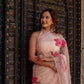 Elegant beige floral chiffon saree with pink flowers, styled for a traditional look
